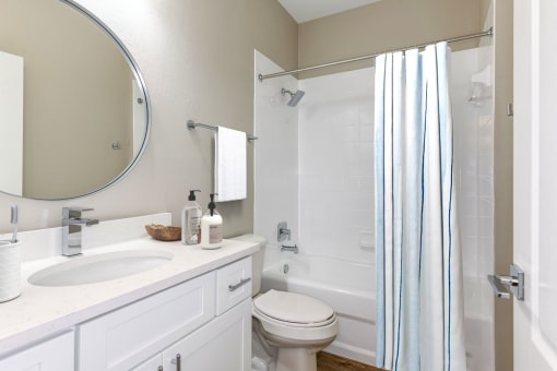 Bathroom equipped with sink, vanity, toilet, and full shower/bath