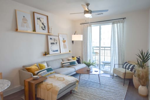 Bright and airy living room Chef-inspired kitchen with undermount sink, pull-down faucet, and plenty of pantry space at The Maven, Suwanee, 30024