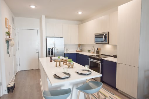 Chef-inspired kitchen with undermount sink, pull-down faucet, and plenty of pantry space at The Maven, Suwanee, GA, 30024