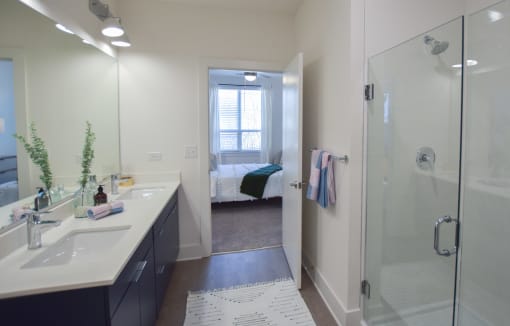 Bathroom with glass shower at The Maven, Suwanee