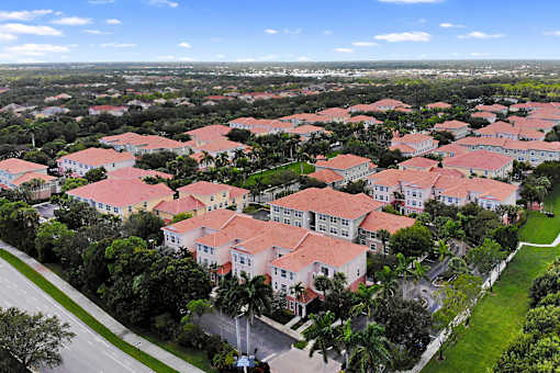 A large housing complex with red roofs and white walls.
