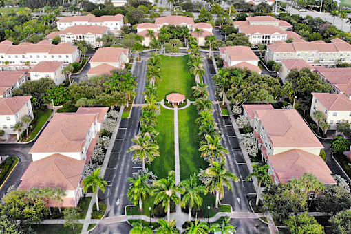 A large green lawn surrounded by buildings.