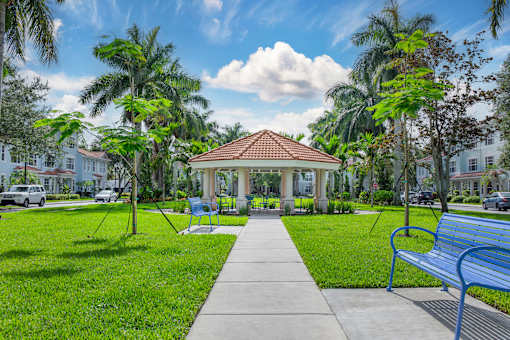 A park with a gazebo, benches, and trees at Floresta apartments in Jupiter, FL