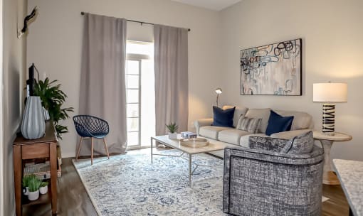 Living room with patio access at The Station at River Crossing, Macon, GA