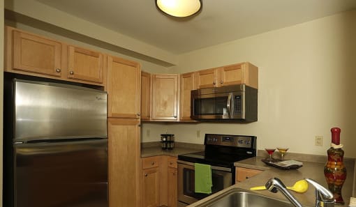 Kitchen appliances include range, refrigerator, dishwasher, and microwave |Residences at Manchester Place
