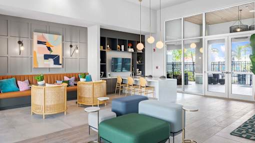 A modern living room with a sofa, chairs, and a painting on the wall. at Lucie at Tradition Apartments, Florida