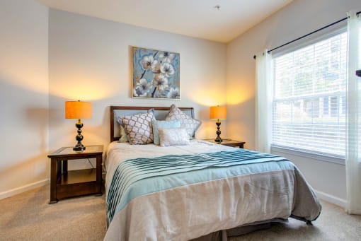 a bedroom with a bed and a large window at Thornberry Apartments, North Carolina, 28262