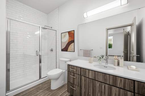 A bathroom with a white toilet, a sink, and a mirror.