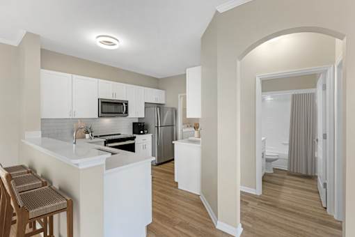 Open-Concept Kitchen and bar with stainless steel appliances and modern finishes