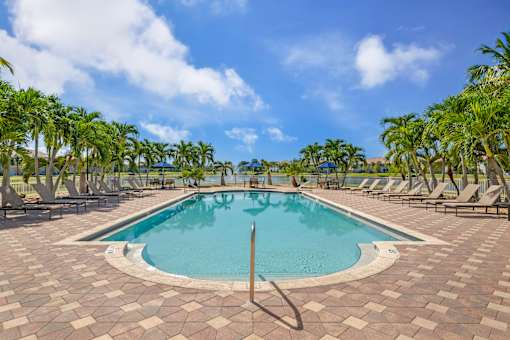 Resort-style swimming pool surrounded by lounge chairs