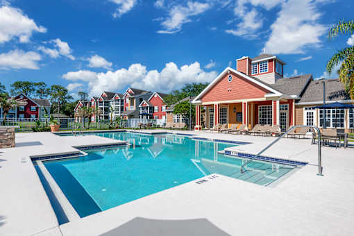 A large swimming pool in front of a house.