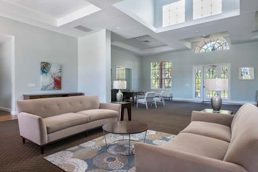 A living room with a couch, a coffee table, and a rug.