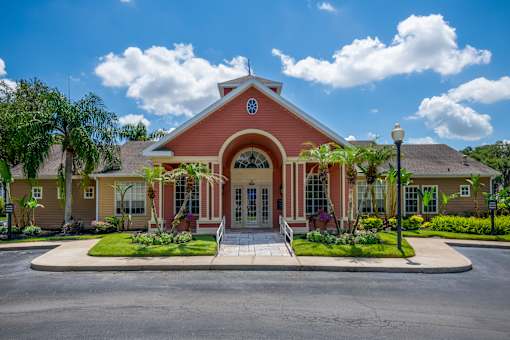 A red building with a circular window on the top.