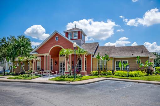 A red building with a white roof and a clock on the front.