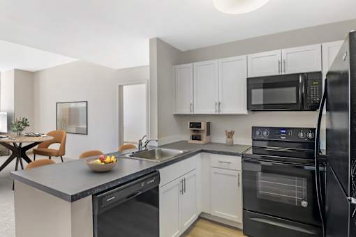 Open Concept Kitchen with white cabinets and wood style plank flooring