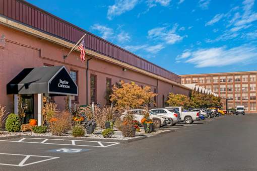 A parking lot in front of the leasing office for Bigelow Commons