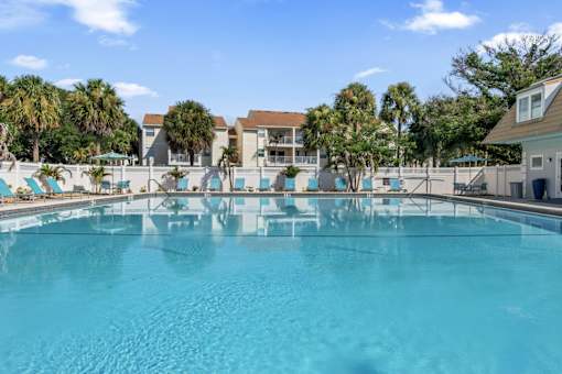 A large swimming pool with a blue tinted water.