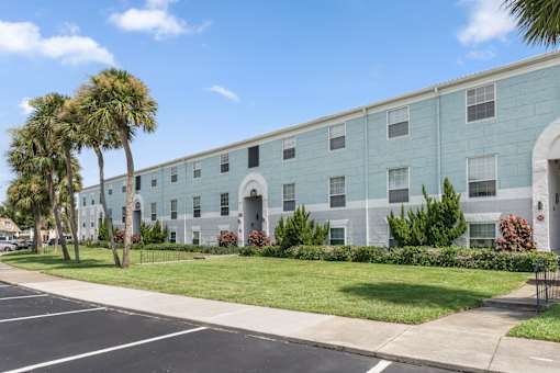 A long building with a white door and windows.