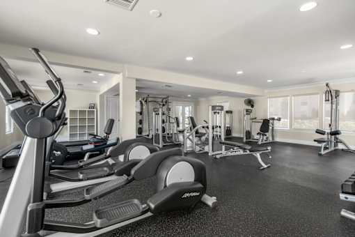 A well-equipped gym with a variety of machines and weightlifting equipment.