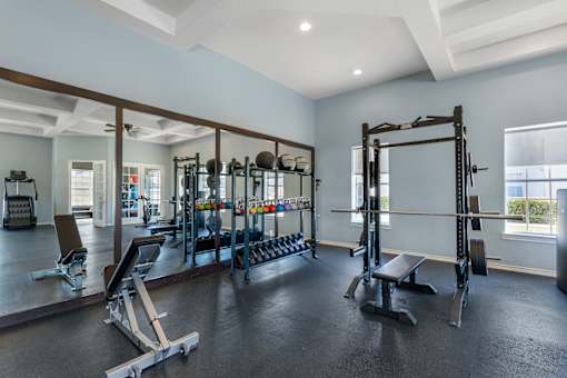 A spacious home gym with a variety of equipment.