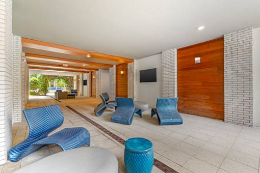 A room with blue chairs and a white table.