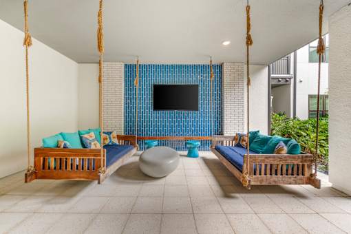 A room with a blue screen and two wooden beds.