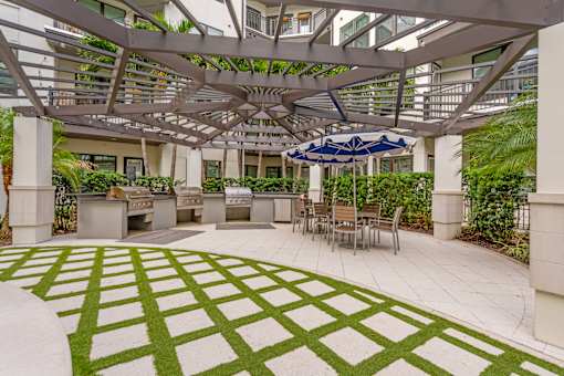 A patio with a green and white patterned lawn.