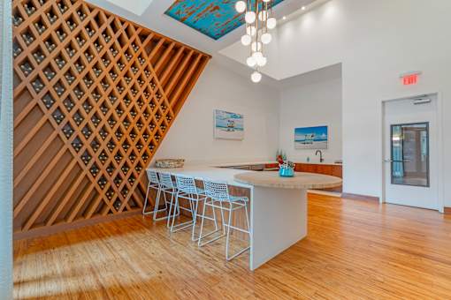 A kitchen with a white island and a wine rack.