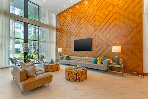 A living room with a wooden wall and a flat screen TV.