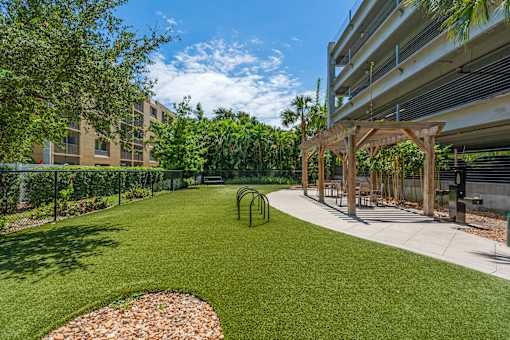 A playground area with a slide and a swing set.