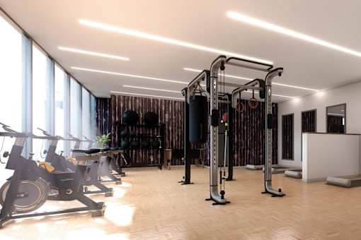 A gym with a row of exercise bikes and a row of weight machines. at Element, Florida, 33602