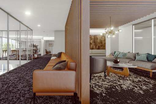 A modern living room with a long sofa and a coffee table. at Element, Tampa