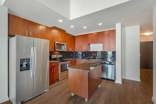 A kitchen with wooden cabinets and stainless steel appliances