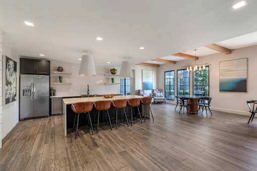A modern kitchen with a dining table and chairs.