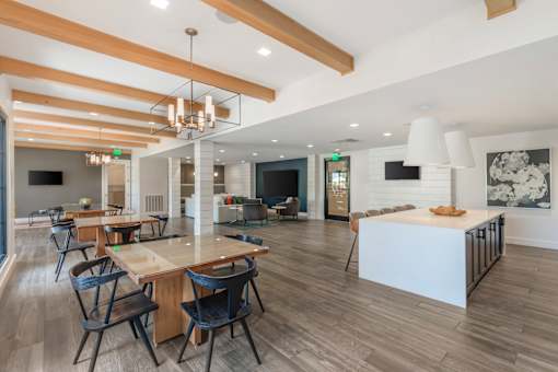 A modern dining room with a long table and chairs.