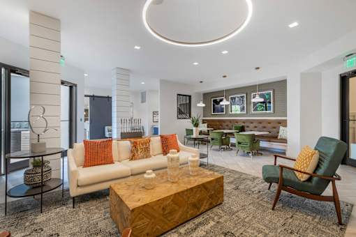 A living room with a white couch and a wooden coffee table.
