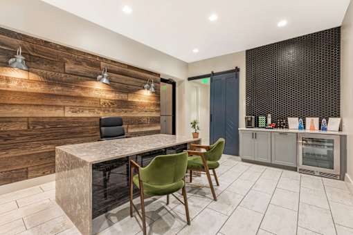 A modern kitchen with a wooden wall and a marble table.