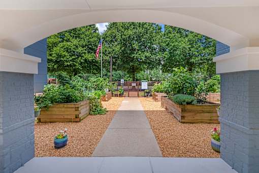 A garden with a flag and a walkway.