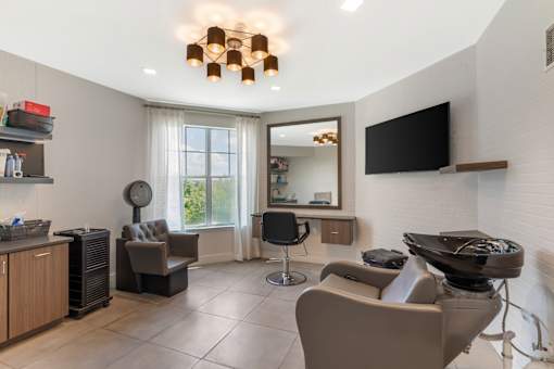 A modern living room with a grey sofa and a black television.