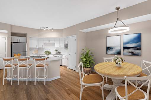 A modern kitchen with a dining table set for four.