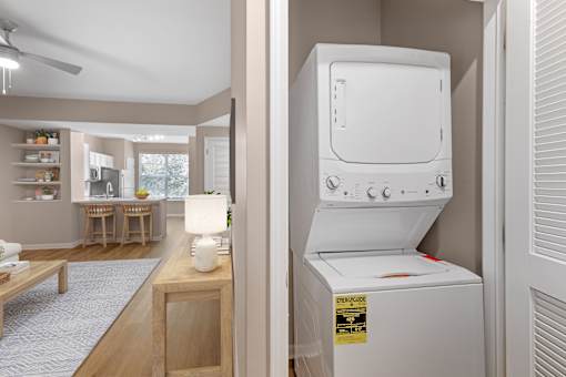 A white oven is in a kitchen with a fan on the ceiling.