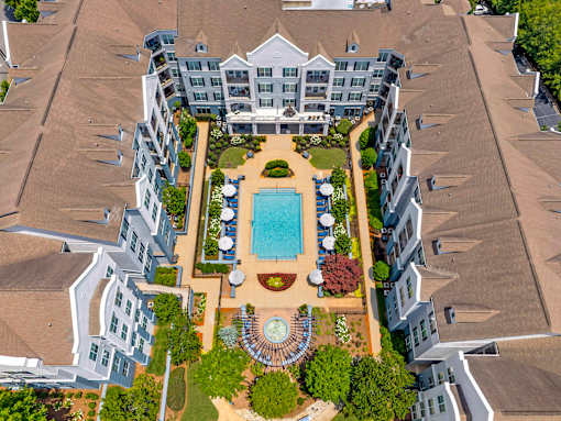 A large building with a pool in the middle of a courtyard.