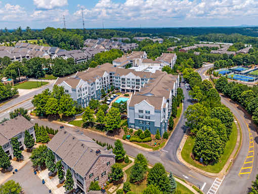 A bird's eye view of a residential area with apartment buildings and houses.