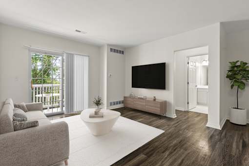 A modern living room with a grey couch, a white coffee table, and a flat screen TV.