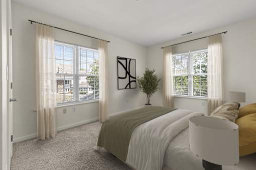 A bedroom with a bed, a chair, and a painting on the wall.