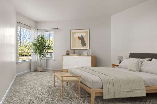 A bedroom with a large bed, a nightstand, and a small table.