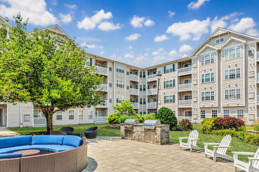 A large apartment complex with a courtyard and seating area.