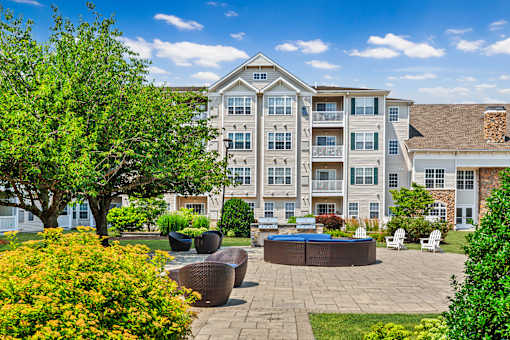 A large apartment complex with a courtyard and seating area.