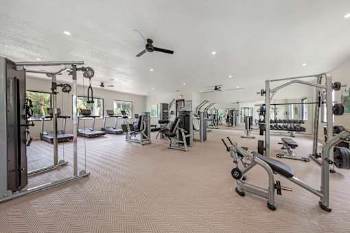 A spacious gym with a variety of equipment.