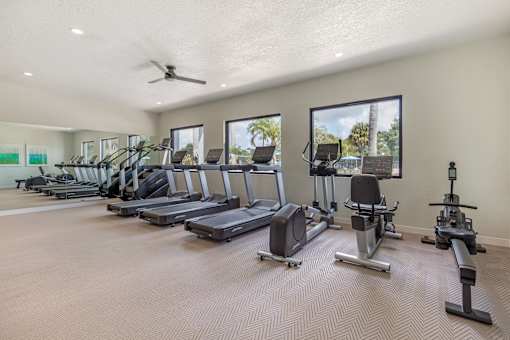 A spacious gym with treadmills, elliptical machines, and other exercise equipment.